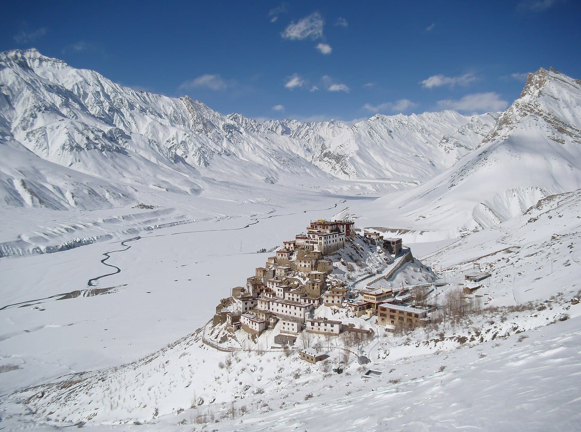 Snow-covered mountain valley and hillside monastery in Spiti